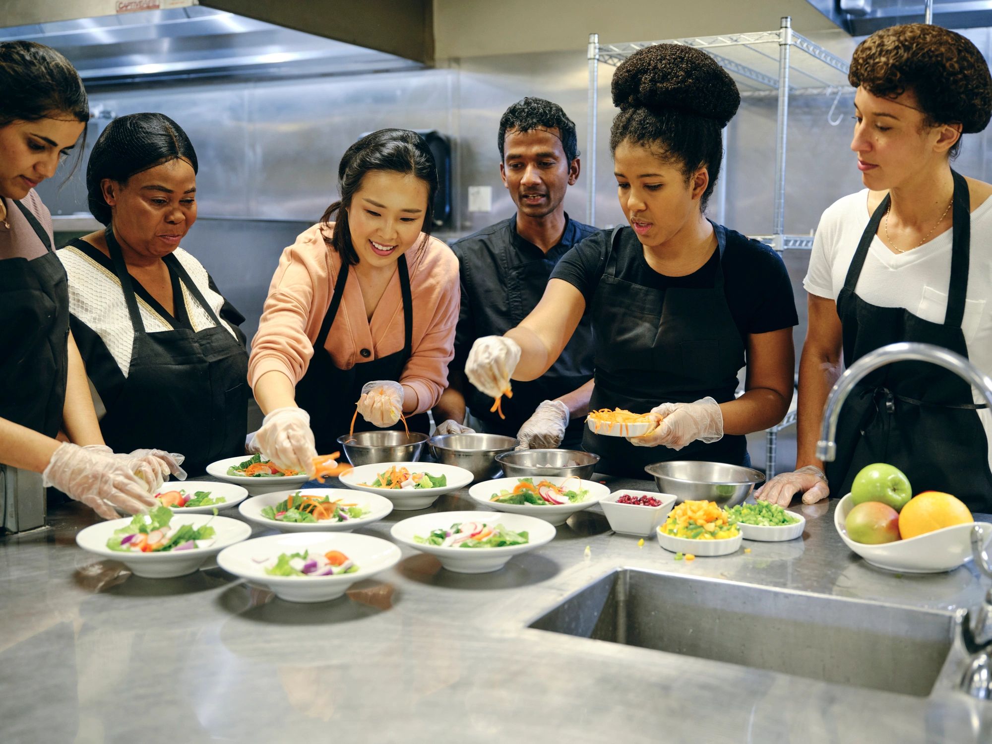 Restaurant kitchen team preparing food together