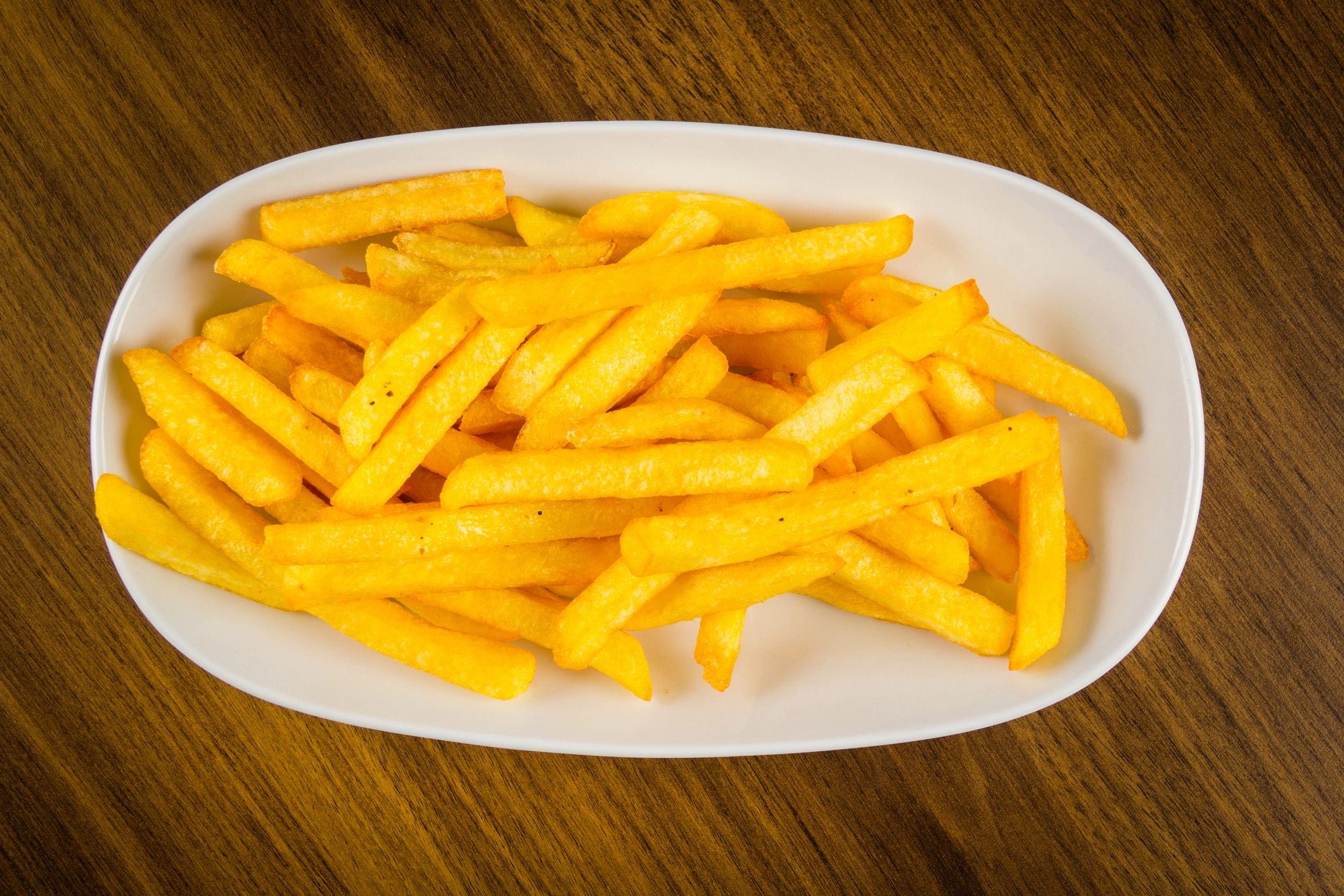 French fries on wooden background